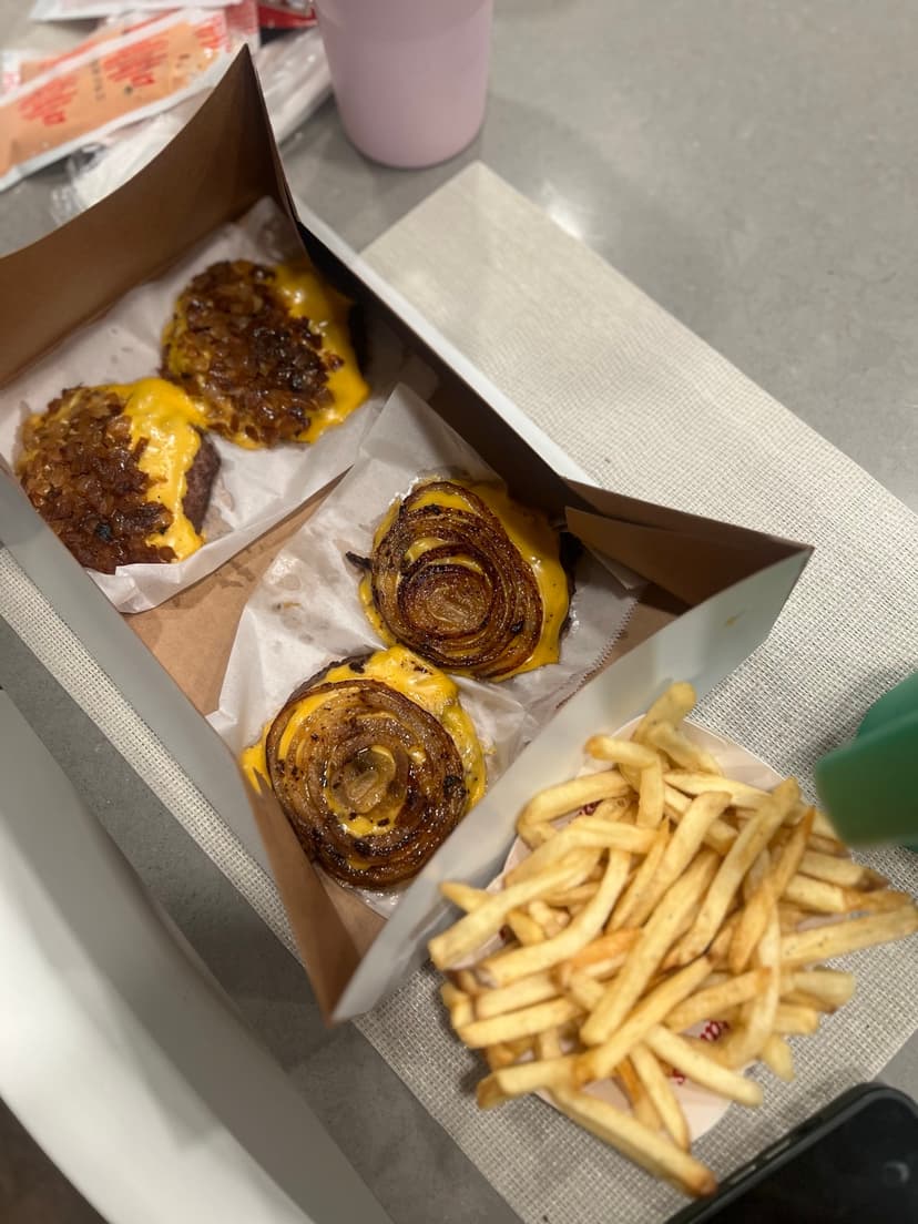 In-N-Out single cheese patties with grilled onions and fries
