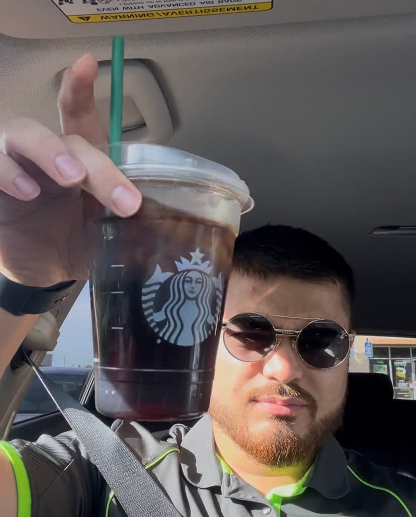 Kyle holding a venti Starbucks black cold brew