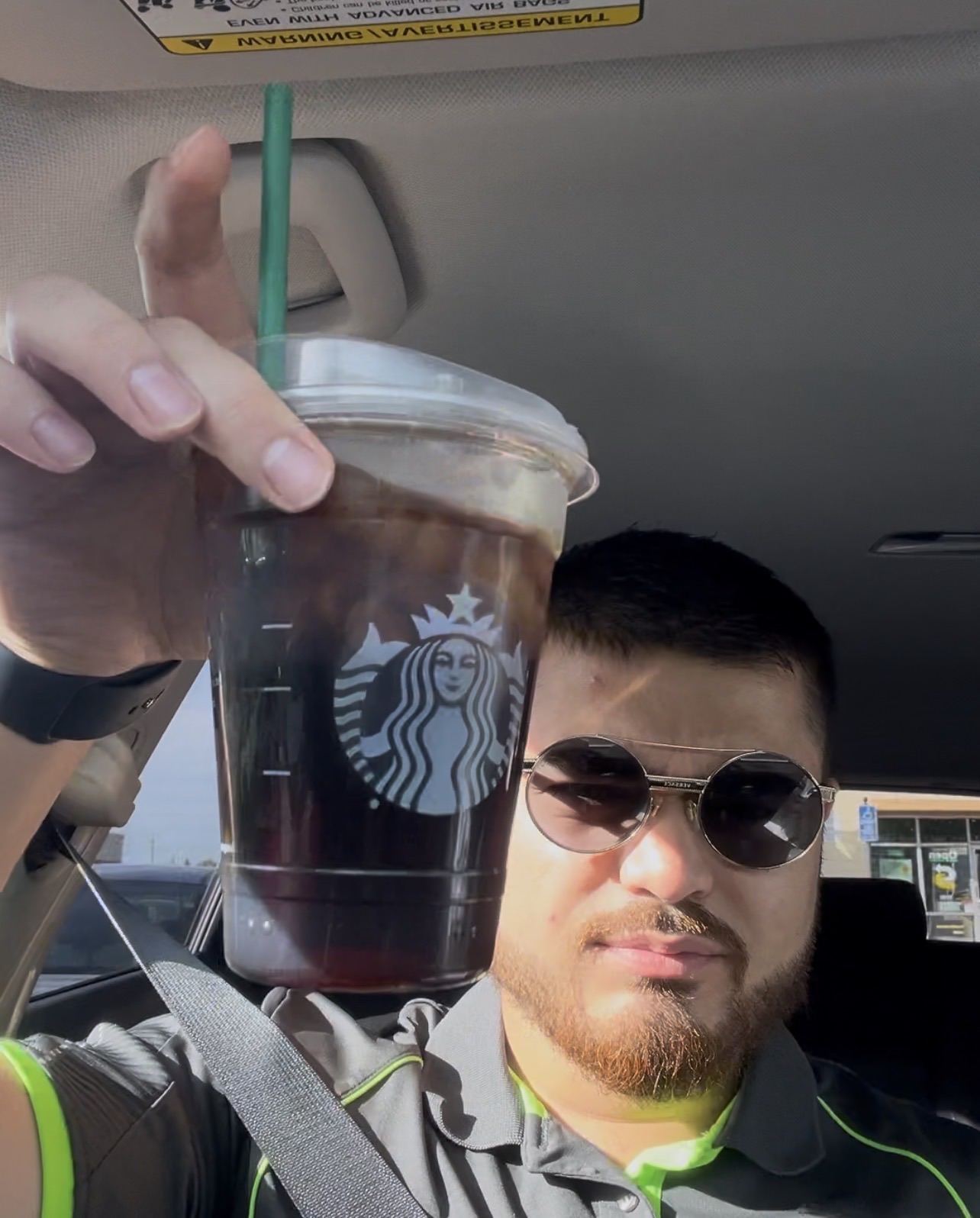 Kyle holding a venti Starbucks black cold brew